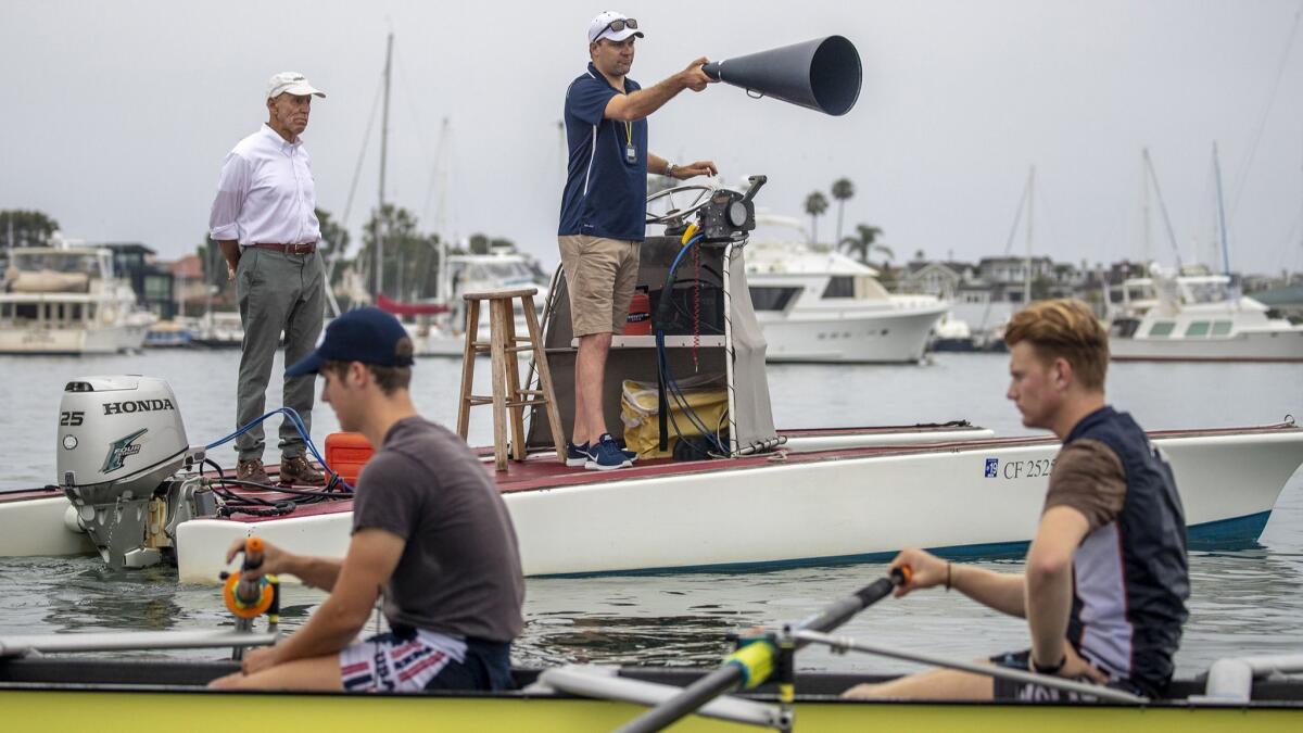 Retired Orange Coast College president David Grant, left, and coach Cameron Brown conduct a training session.