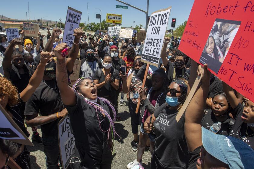 PALMDALE, CA - JUNE 13: Paris Draper, left, leads hundreds of protesters in chants for justice after the death of a young Black man, Robert Fuller, during protest march in Palmdale on Saturday, June 13, 2020 in Palmdale, CA. (Brian van der Brug / Los Angeles Times)