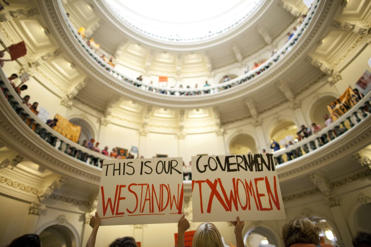 Abortion rights supporters rally on the floor of the state Capitol rotunda in Austin, Texas. A sharply divided Supreme Court on Tuesday allowed Texas to continue enforcing abortion restrictions that opponents say have led more than a third of the state's clinics to stop providing abortions.