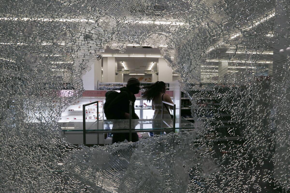 Looters ransack a Walgreens store along Broadway in downtown Los Angeles, Saturday, May 30, 2020.