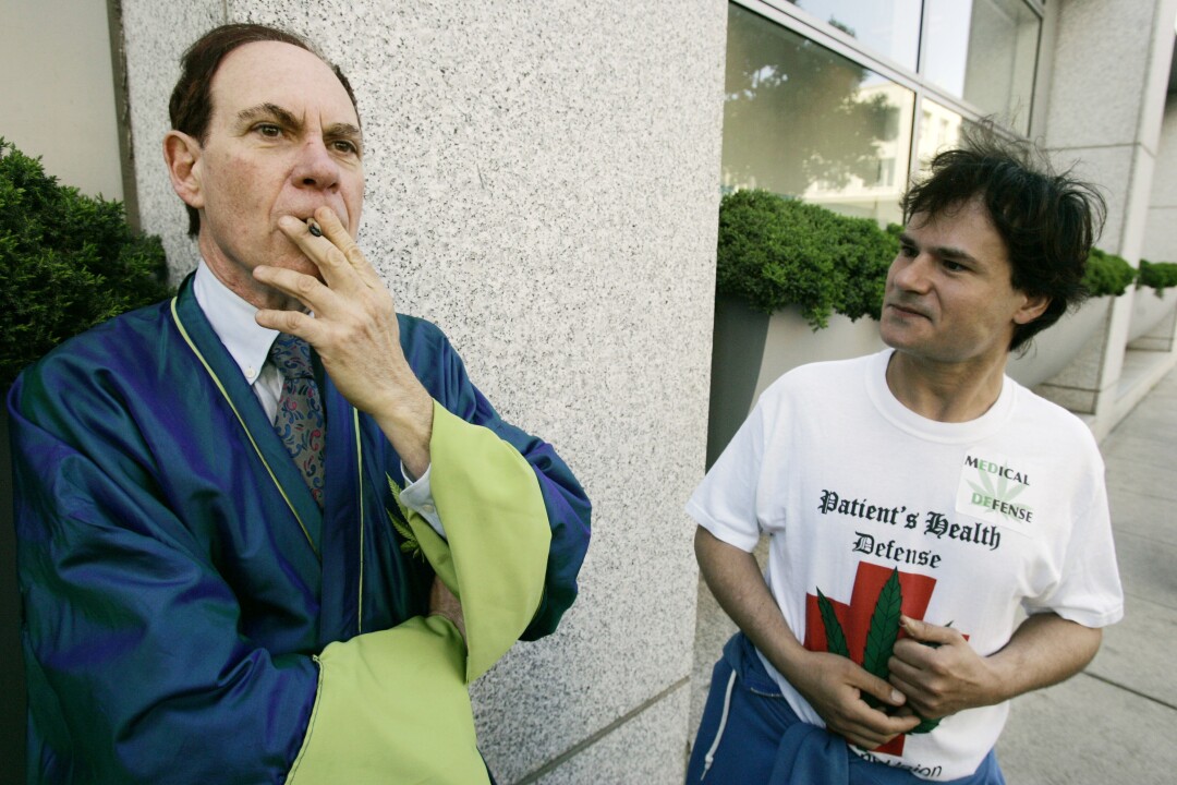 Ed Rosenthal smokes marijuana outside the federal courthouse in San Francisco in 2007 as supporter David Cohen  watches.
