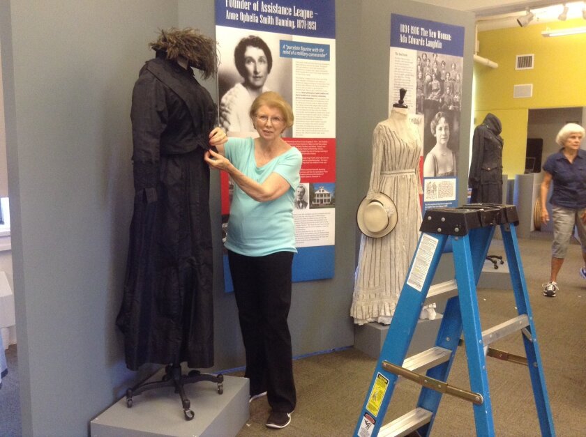 Maggie Brasch, past president of the San Diego Chapter of the Assistance League, helps prepare for the new exhibit at the Women’s Museum of California.