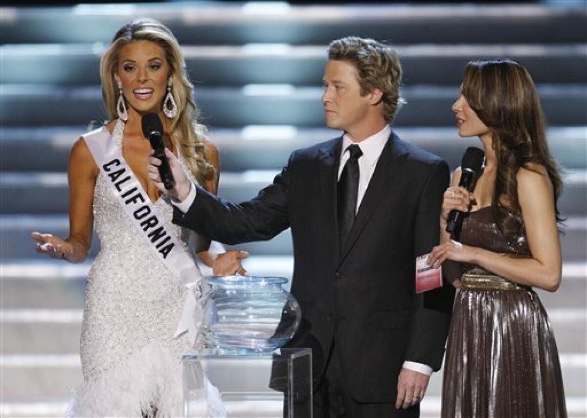 FILE - In this April 19, 2009 file photo, hosts Billy Bush, center, and Nadine Velazquez, right, listen as Miss California Carrie Prejean answers a question from judge Perez Hilton, unseen, about legalizing same-sex marriage during the Miss USA Pageant in Las Vegas. (AP Photo/Eric Jamison, file)