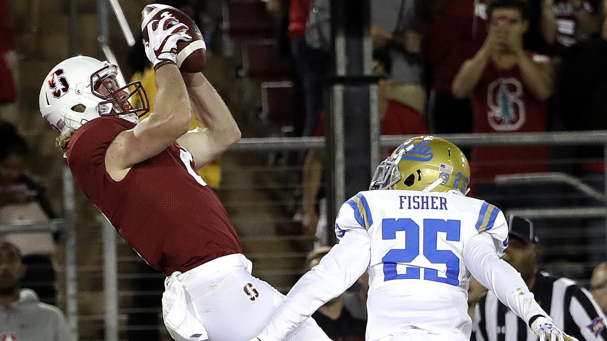 Stanford wide receiver Trenton Irwin makes a touchdown catch against UCLA defensive back Denzel Fisher during the second half of their game Saturday.