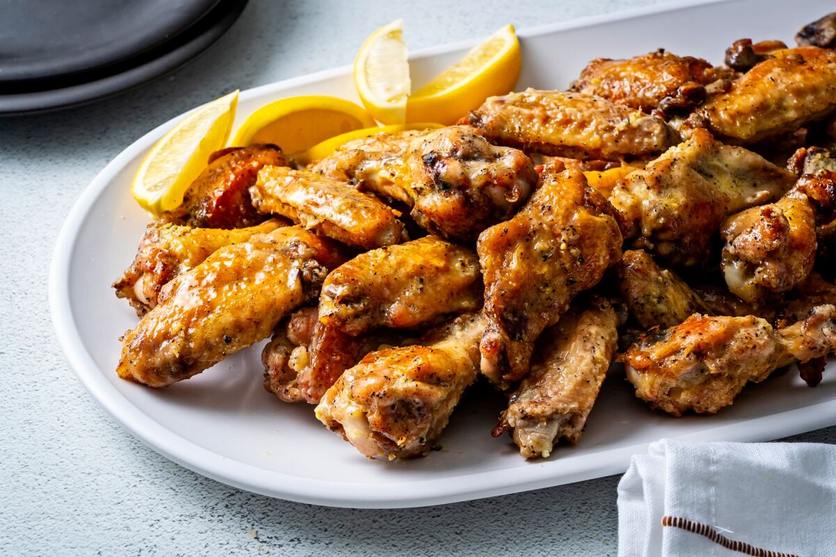 Lemon-pepper chicken wings on a plate.