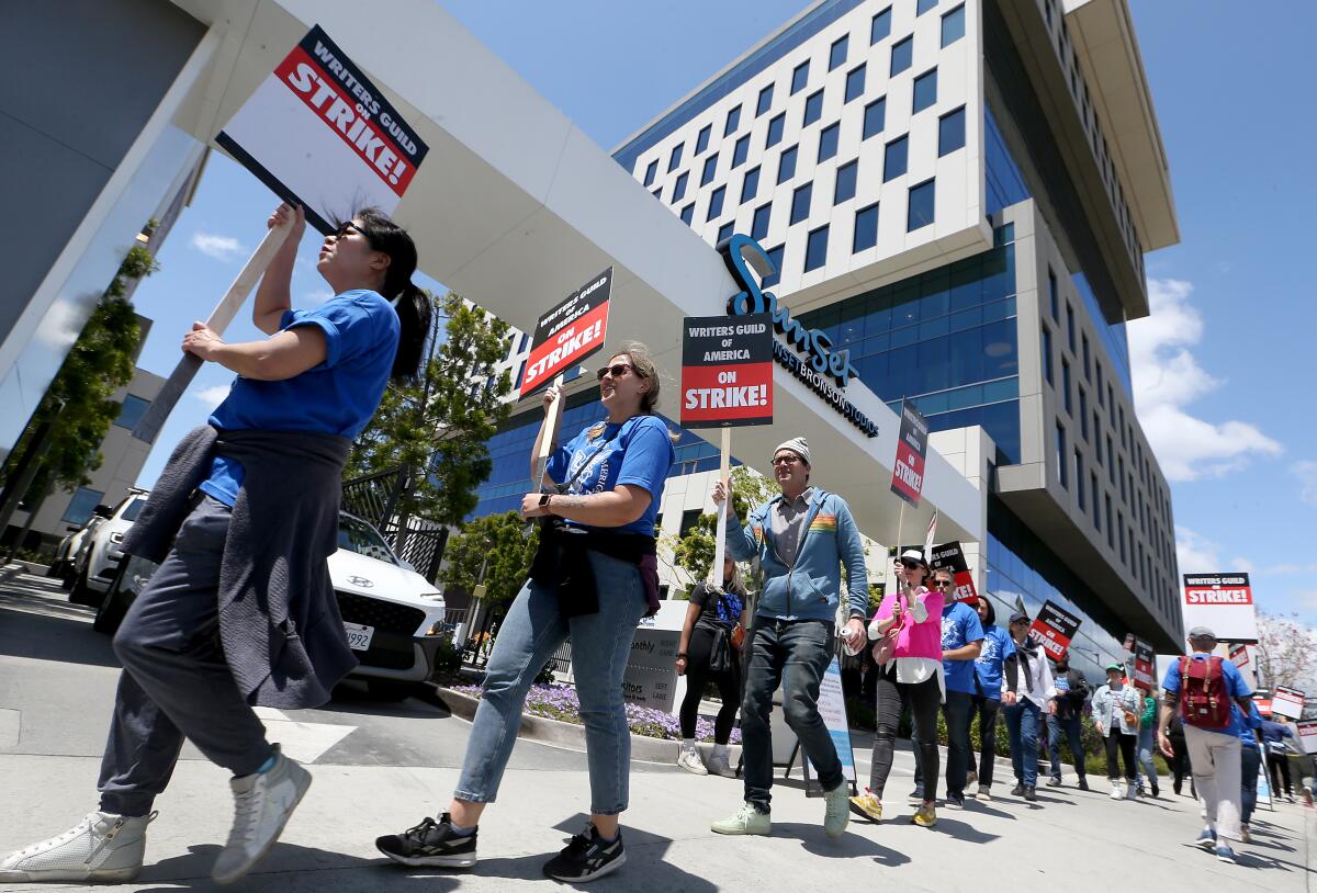 Striking Writers Guild of America workers picket outside the Sunset Bronson Studios in Los Angeles.