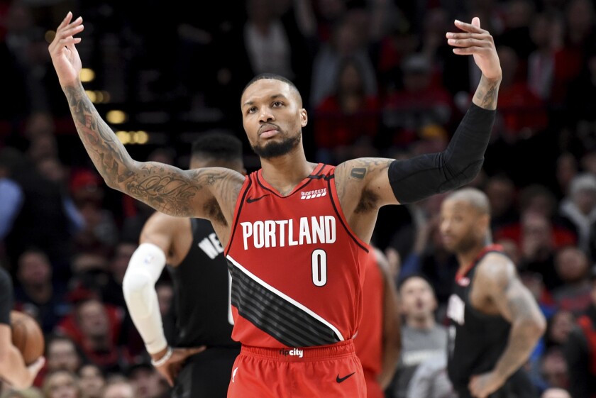 Portland Trail Blazers guard Damian Lillard urges on the crowd after scoring during the second half of the team's NBA basketball game against the Houston Rockets in Portland, Ore., Wednesday, Jan. 29, 2020. The Blazers won 125-112. (AP Photo/Steve Dykes)