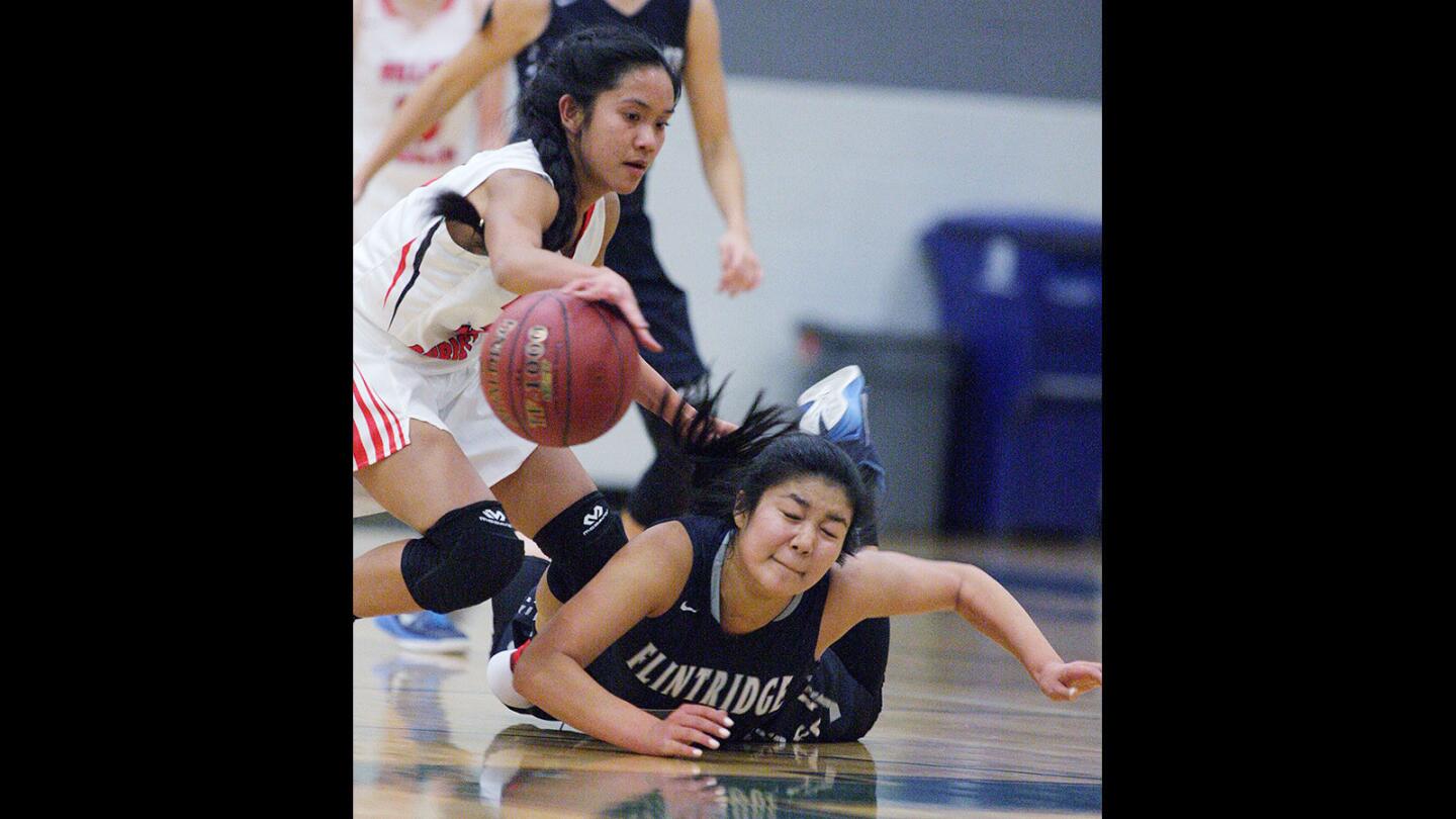 Flintridge Prep's Renae Tamura dives for the steal attempt from Village Christian's Peyton Ruiz in the Paul Sutton Tipoff Classic basketball tournament girls basketball game at Providence High School on Monday, November 30, 2015.