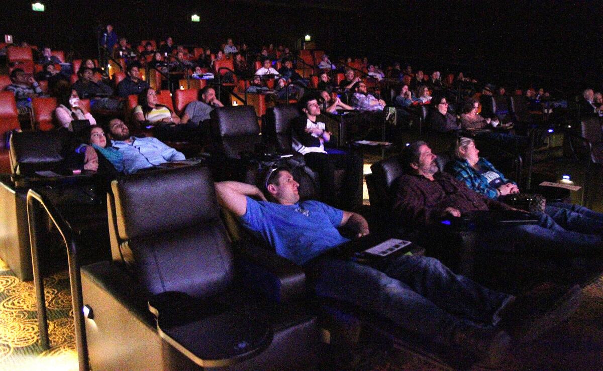 Theater-goers await a screening at the Five Star Cinema in downtown Glendale that shuttered nearly three years ago. A new theater dining chain, Studio Movie Grill, is moving into the space and is expected to open this fall.
