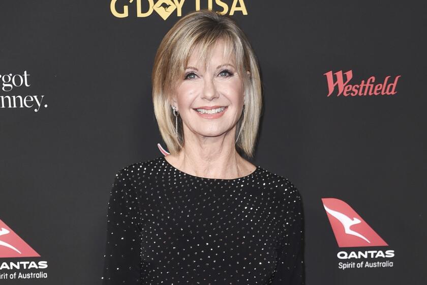 FILE - In this Jan. 27, 2018 file photo, Olivia Newton-John attends the 2018 G'Day USA Los Angeles Gala at the InterContinental Hotel Los Angeles. Two collectors said you’re the one that I want to Newton-John’s iconic “Grease” leather jacket and skintight pants at an auction in Beverly Hills, Saturday, Nov. 2, 2019. Julien’s Auctions says the combined ensemble, which Newton-John’s character Sandy wears in the closing number of the 1978 film, fetched $405,700 total. The leather jacket sold for $243,200 and the pants, which Newton-John famously had to be sewn into, went for $162,500. (Photo by Richard Shotwell/Invision/AP, File)