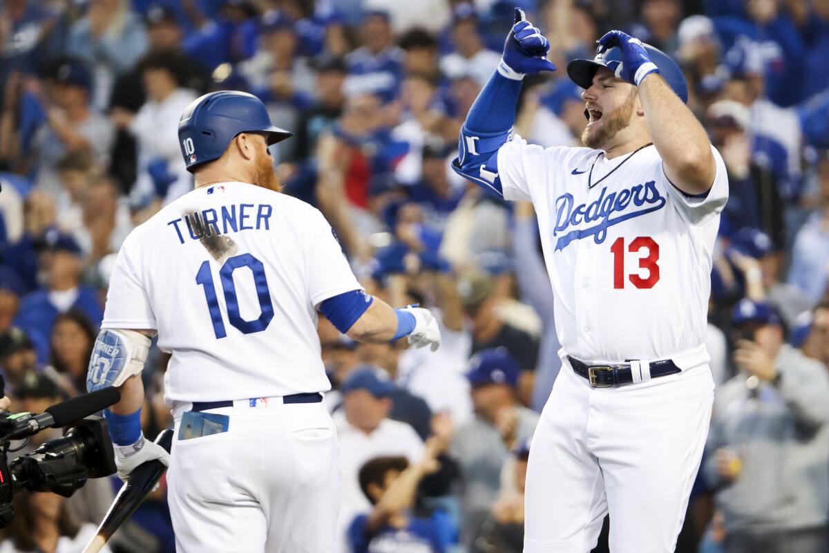 Max Muncy, right, celebrates with Justin Turner after hitting a solo home run.