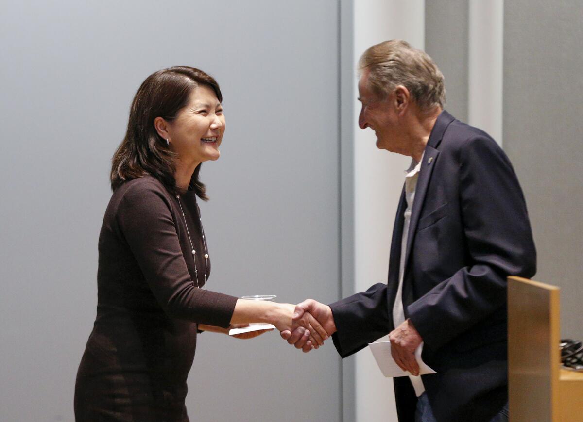 Newport Beach City Manager Grace Leung, left, is introduced by Ed Selich of Speak Up Newport.