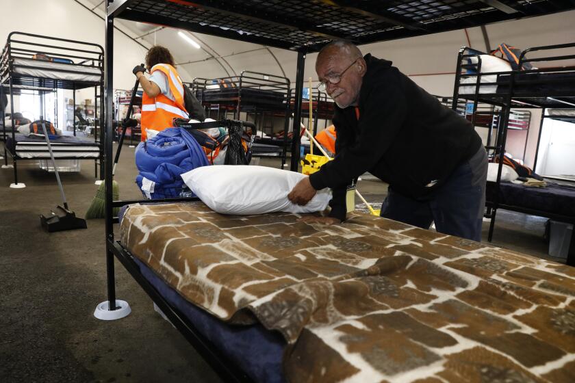 472642-sd-me-tent-shelter_NL San Diego, CA November 14, 2019 Robert Zepeda, 74, unpacks some of his belongings and makes his bed, at the city's fourth bridge opened on Thursday morning. The shelter, managed by the Alpha Project, is the fourth bridge shelter to open in San Diego and is located near 17th and Imperial Aves. © 2019 Nancee E. Lewis / Nancee Lewis Photography.