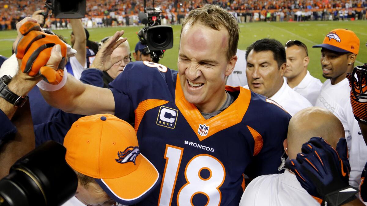 In Sunday's victory over the San Francisco 49ers, Denver Broncos quarterback Peyton Manning celebrates with teammates and members of the team staff after breaking the record for most career touchdown passes.