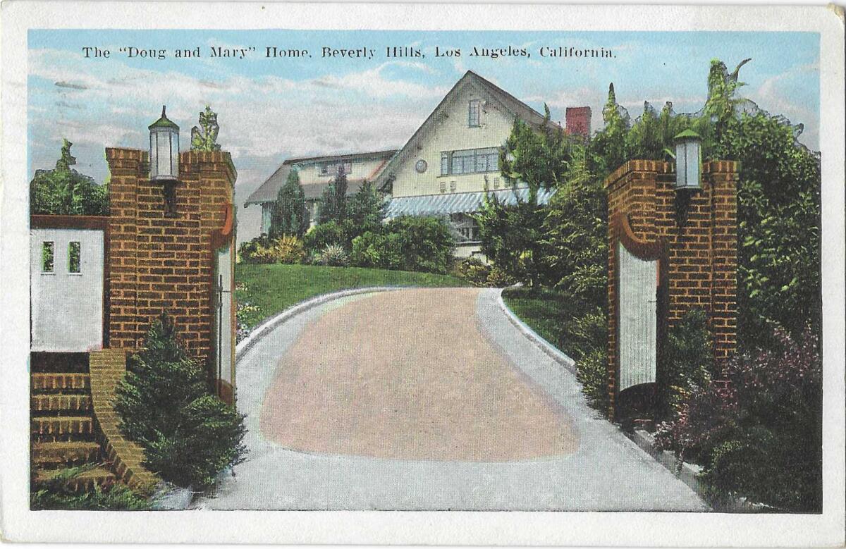 Open gates reveal a long driveway and the home of two of the biggest stars of the silent film era
