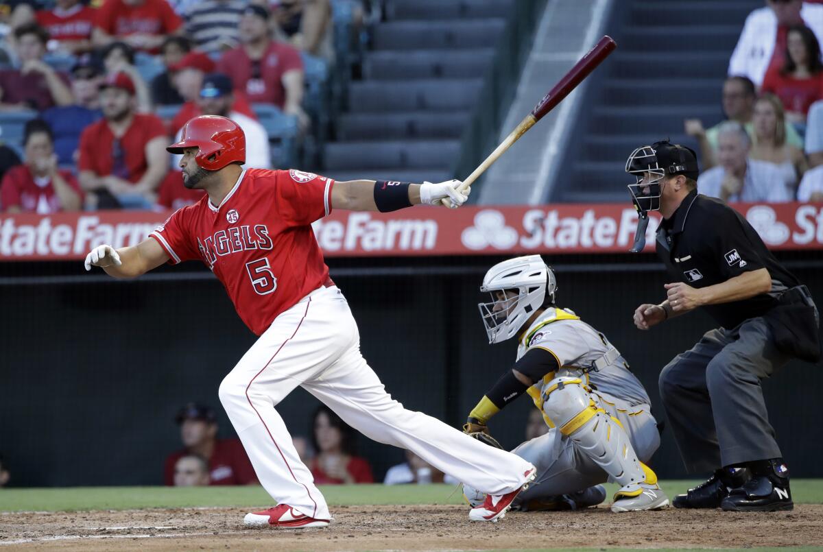 Angels' Albert Pujols singles in a run against the Pittsburgh Pirates during the fourth inning.