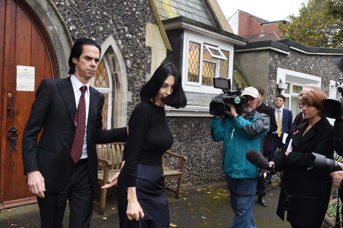 Musician Nick Cave and his wife, Susie Bick, attend an inquest into their son's death in Brighton, England. Arthur Cave, 15, died July 14.