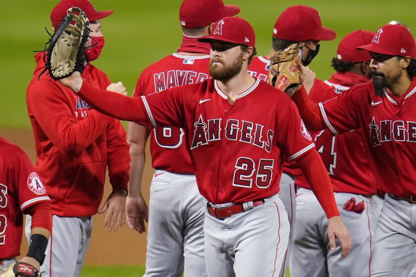 Los Angeles Angels first baseman Jared Walsh celebrates with teammates after a baseball game.