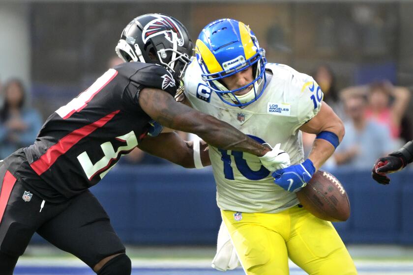 Inglewood, California September 18, 2022-Rams receiver Cooper Kupp has the ball punched out of his arms by Falcons cornerback Darren Hall late in the fourth quarter at SoFi Stadium Sunday. The Falcons recovered the ball. (Wally Skalij/Los Angeles Times)
