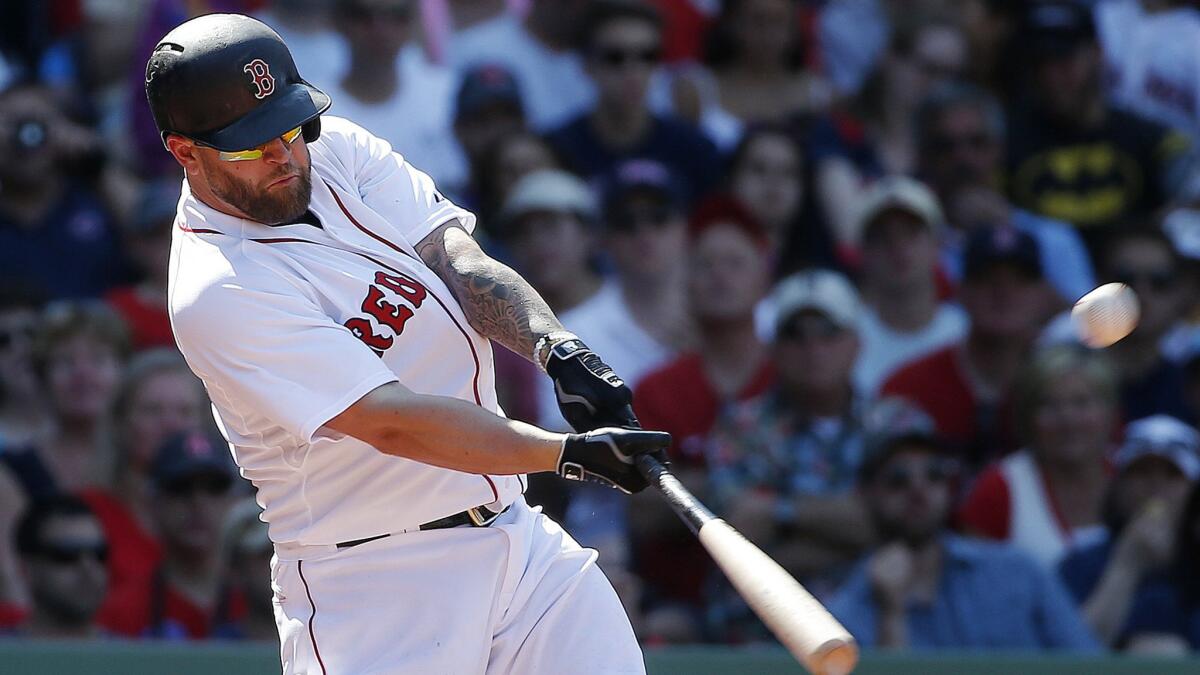 Boston Red Sox first baseman Mike Napoli hits a two-run double during the eighth inning of a 6-1 win over the Angels on Sunday.