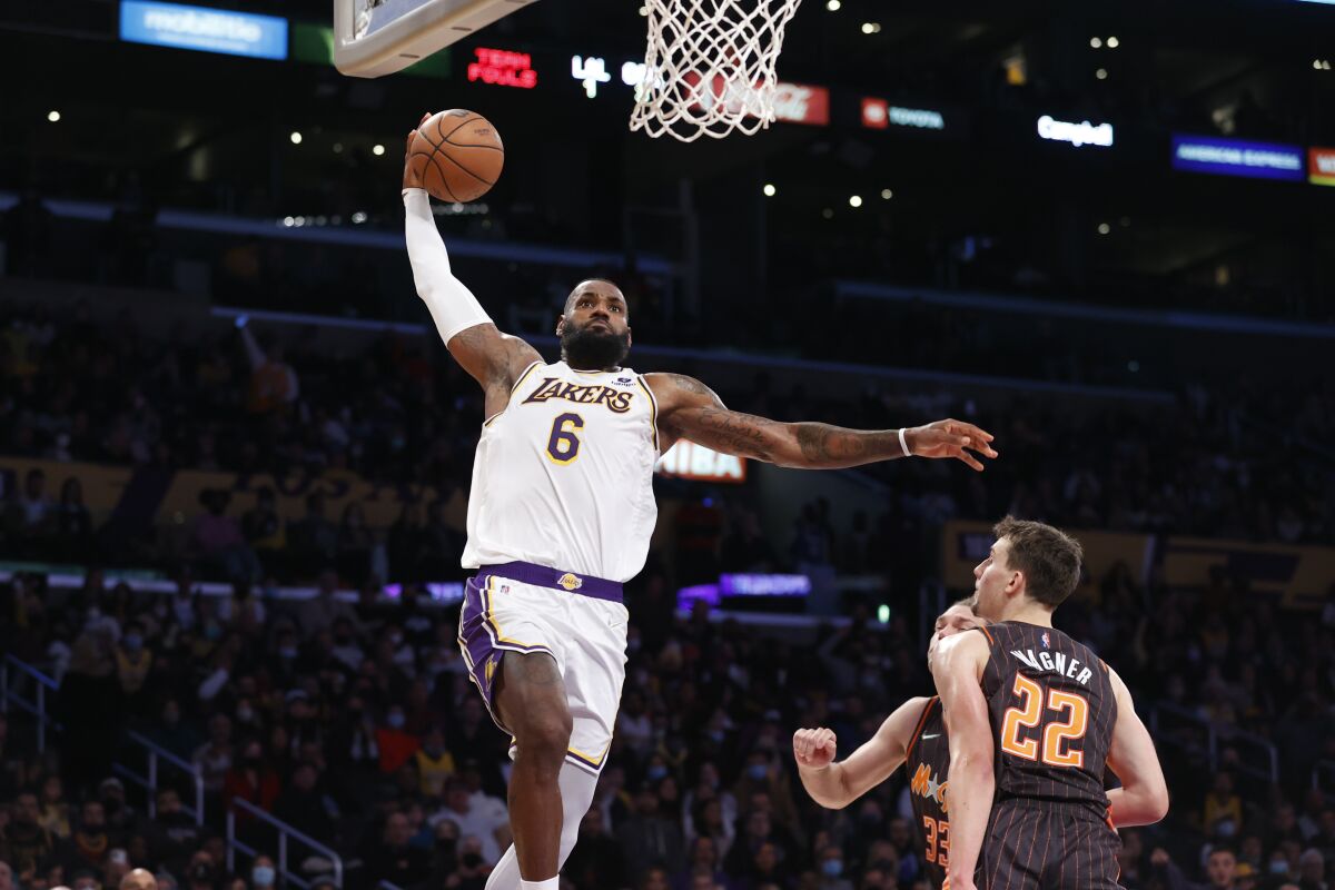 Lakers forward LeBron James goes up for a dunk against the Orlando Magic.