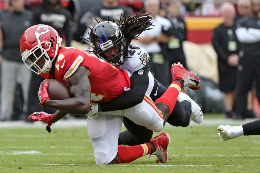 Kansas City Chiefs wide receiver Sammy Watkins (14) is tacklled by Baltimore Ravens cornerback Maurice Canady (26) during the first half of an NFL football game in Kansas City, Mo., Sunday, Sept. 22, 2019. (AP Photo/Ed Zurga)