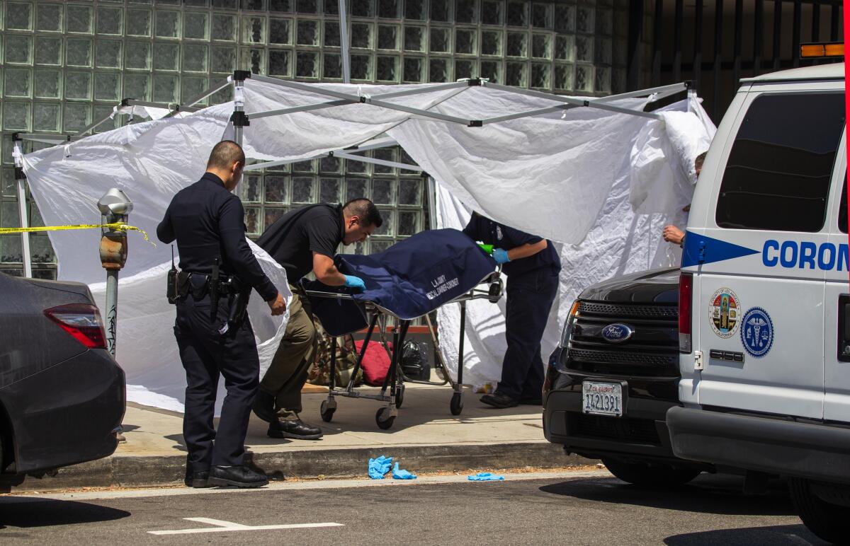 An LAPD officer assists investigator Adrian Munoz