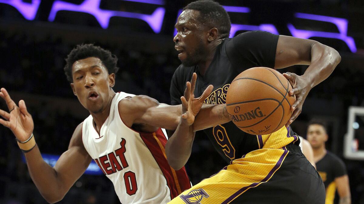 Lakers forward Luol Deng drives to the basket against Heat guard Josh Richardson during the second half Friday night.