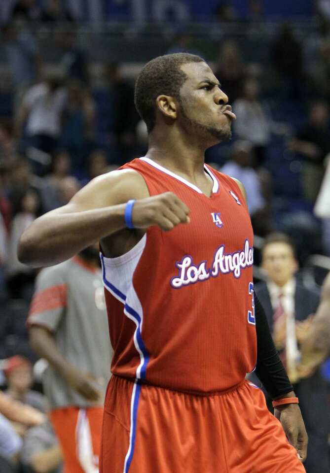 Point guard Chris Paul celebrates after helping the Clippers defeat the Magic, 107-102, in overtime on Monday night in Orlando.