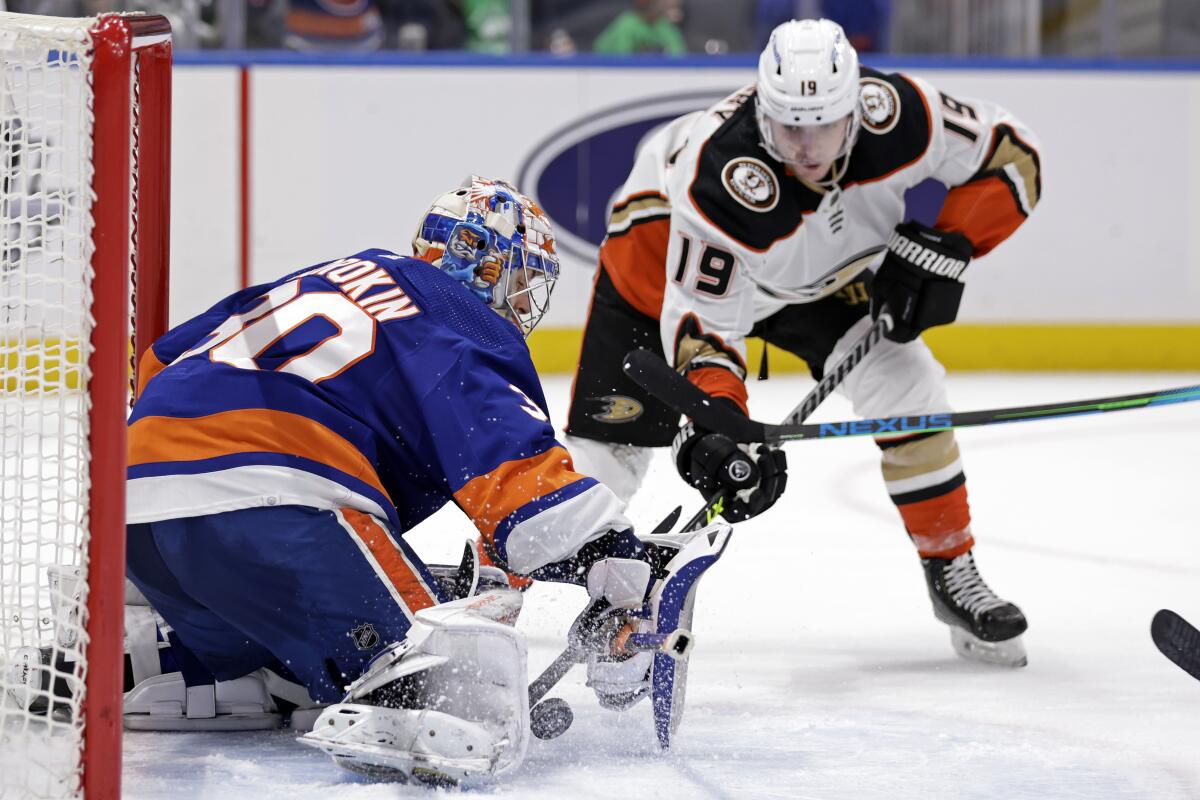 New York Islanders goaltender Ilya Sorokin, left, makes a save on a shot by Ducks forward Troy Terry.