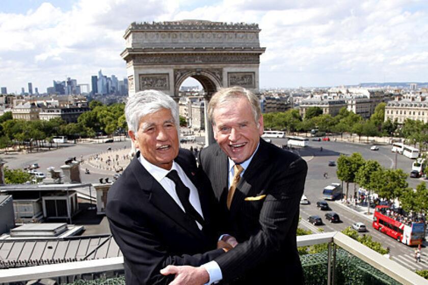 Maurice Levy, left, chief executive of French advertising firm Publicis Groupe, and John Wren, head of Omnicom Group Inc., at a Paris news conference announcing their firms' merger plans.
