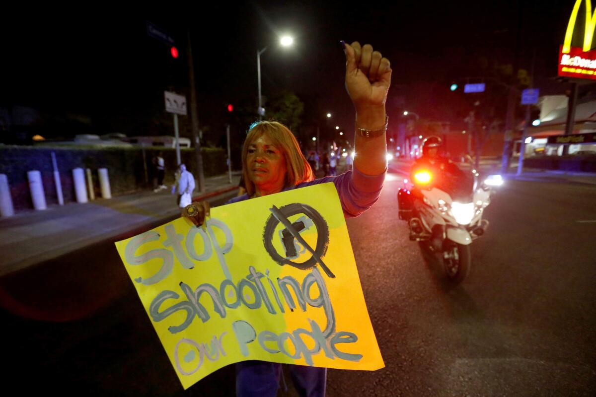 Marian Petersen, 71, whose last protest was in the 1965 Watts riots, marches down Central Avenue to the LAPD's Newton Division station after officers shot a Latino boy Sunday night.