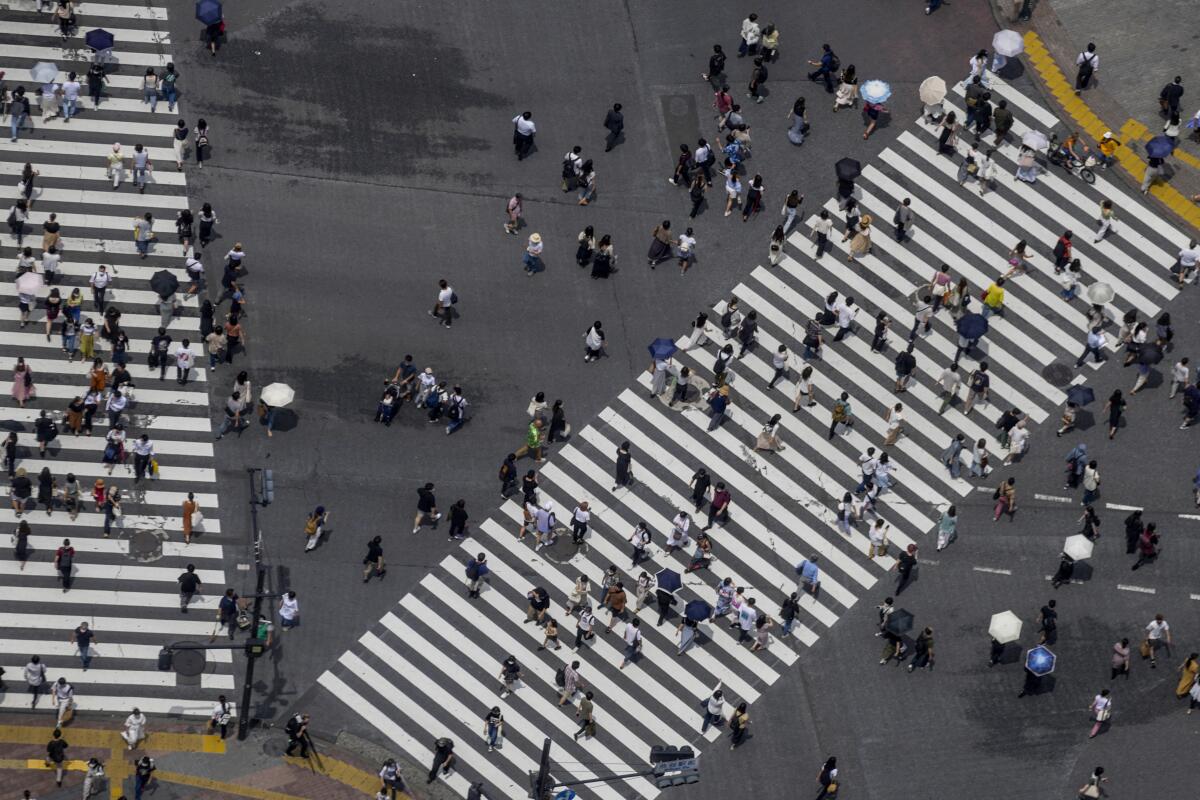 View from above of people in crosswalks  