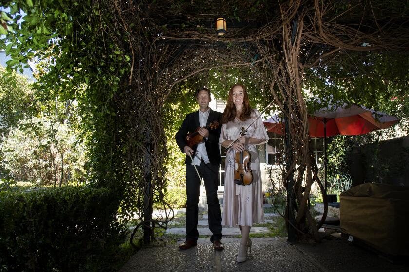 SOUTH PASADENA, CA - MARCH 1, 2021: Los Angeles Chamber Orchestra members Tereza Stanislav and Rob Brophy under their backyard pergola during the pandemic on March 1, 2021 in South Pasadena, California.(Gina Ferazzi / Los Angeles Times)