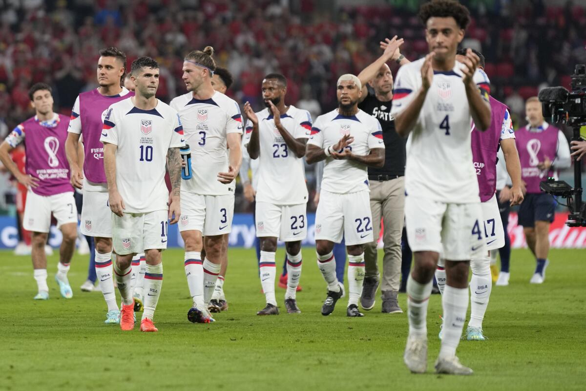U.S. players leave the field after playing to a 1-1 tie against Wales at the World Cup on Monday.