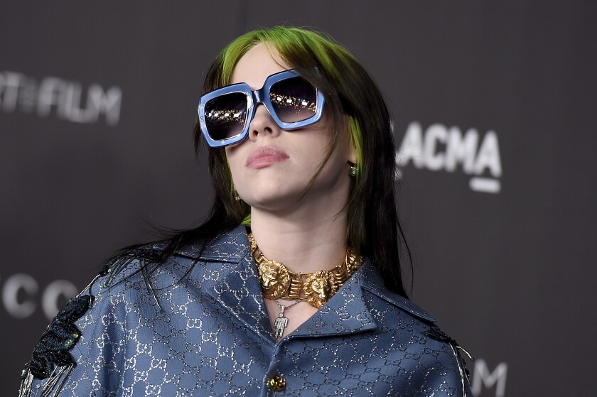 FILE - This Nov. 2, 2019 file photo shows singer Billie Eilish at the 2019 LACMA Art and Film Gala in Los Angeles. Eilish is set to the sing the theme song for the upcoming James Bond film, becoming the youngest act to write and record a song for the iconic film franchise. Eilish, who turned 18 in December, recorded the song for the 25th Bond film, “No Time to Die," which debuts in U.S. theaters on April 10. (Photo by Jordan Strauss/Invision/AP, File)