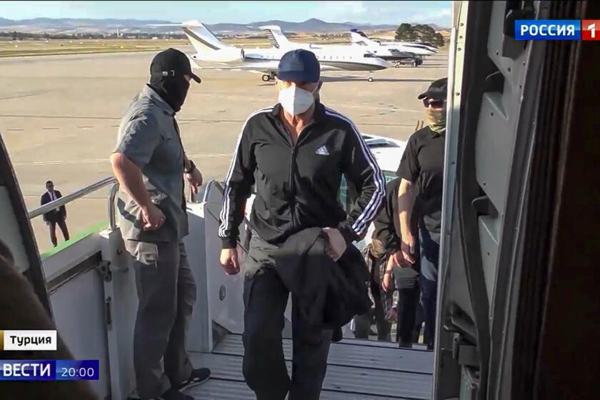 In this image provided by Russian Federal Security Service, Russian Vadim Krasikov, who was convicted in 2021 of shooting to death Zelimkhan "Tornike" Khangoshvili, walks up into a Russian plane at the Ankara Airport, Turkey, Thursday, Aug. 1, 2024. Krasikov was released in part that set some two dozen people free in a multinational prisoner swap, according to officials in Turkey, where the exchange took place. (Russian Federal Security Service/RTR via AP)