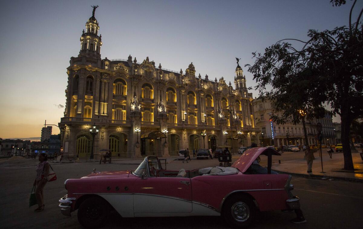 A classic American convertible parked outside the National Theatre in Havana where President Obama is expected to speak during his upcoming trip.