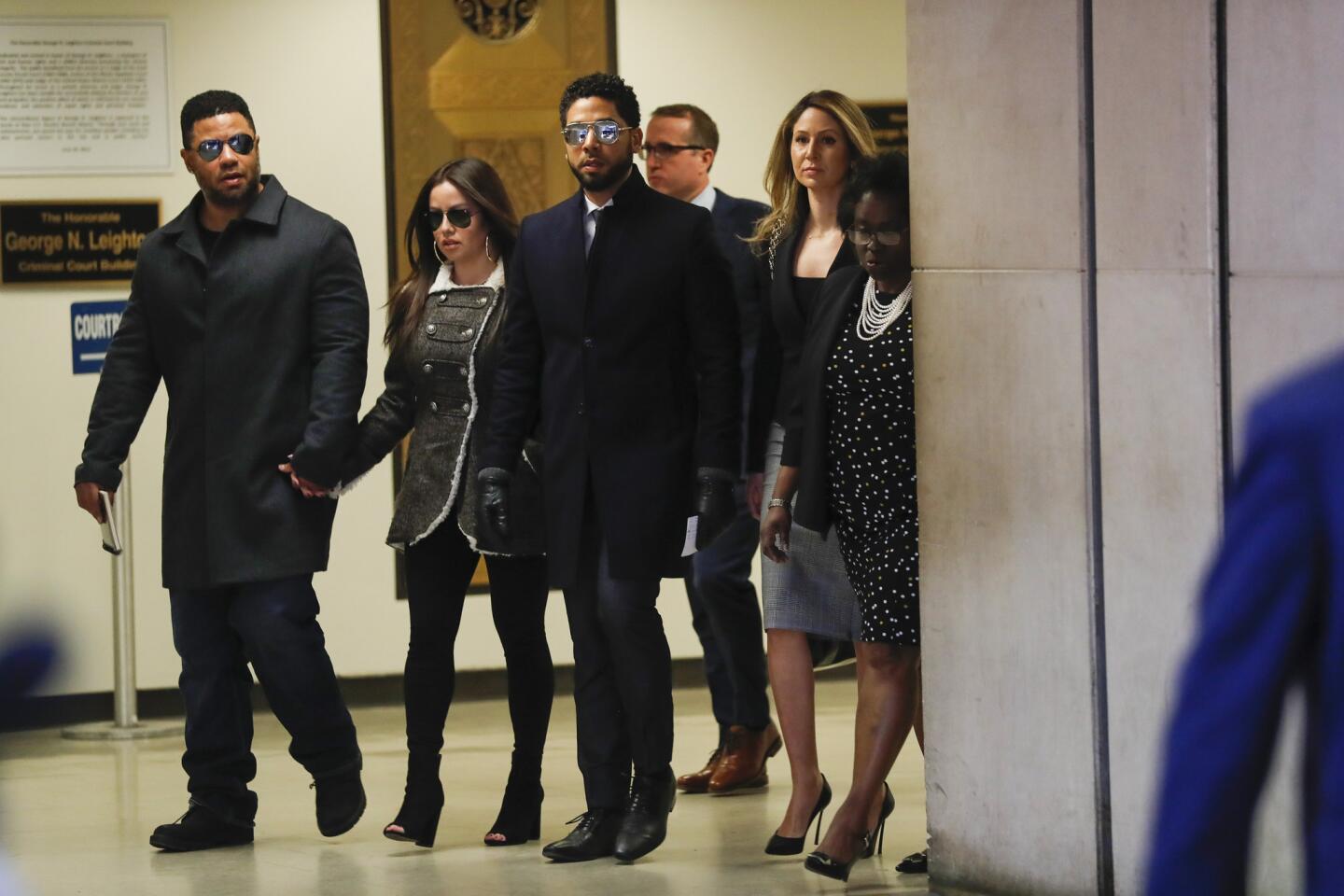 Jussie Smollett, third from left, walks out to speak to the media after all charges against him are dropped at the Leighton Criminal Court Building in Chicago on March 26, 2019.