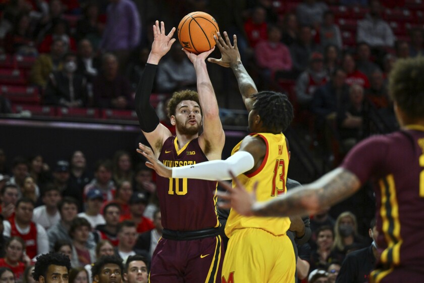 Minnesota forward Jamison Battle (10) shoots the ball against Maryland guard Hakim Hart (13) during the first half of an NCAA college basketball game, Wednesday, March 2, 2022, in College Park, Md. (AP Photo/Terrance Williams)