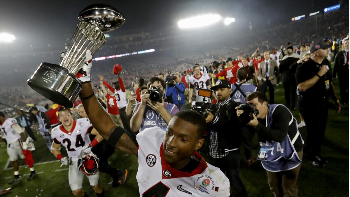 Georgia wide receiver Mecole Hardman hoists the winner's trophy after the Bulldogs beat the Oklahoma Sooners, 54-48, in the Rose Bowl.