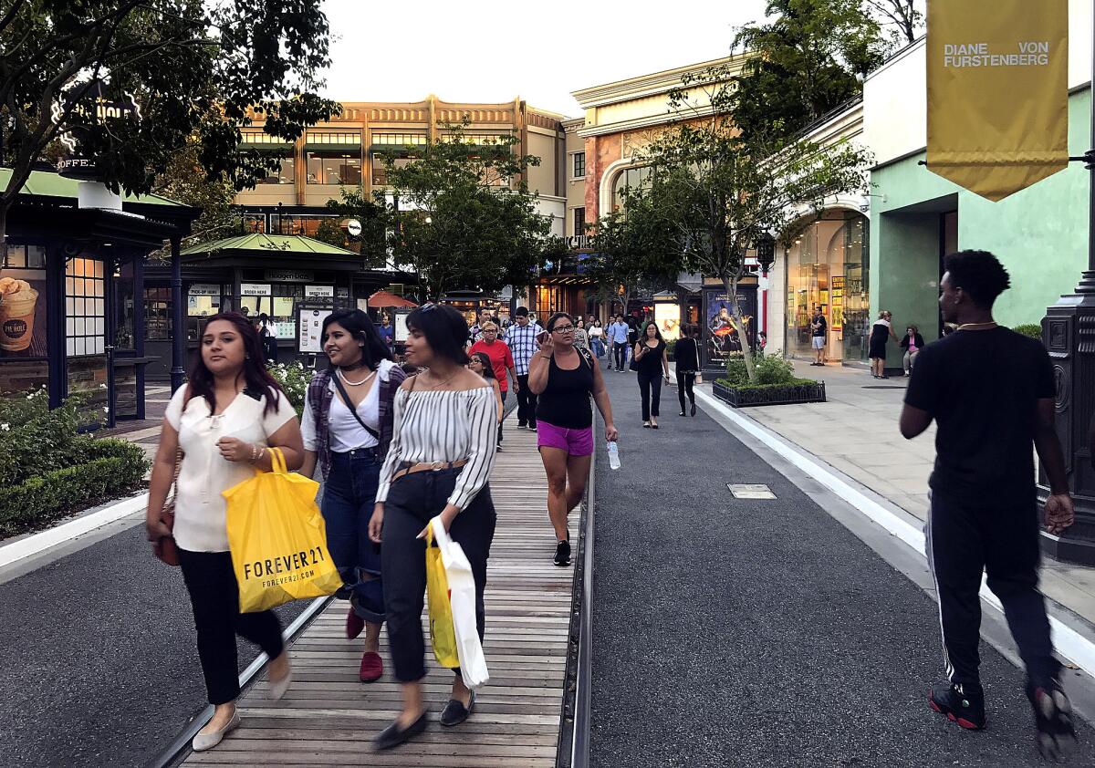 Shoppers stroll the grounds of the Americana at Brand shopping center in Glendale. (Mel Melcon / Los Angeles Times)