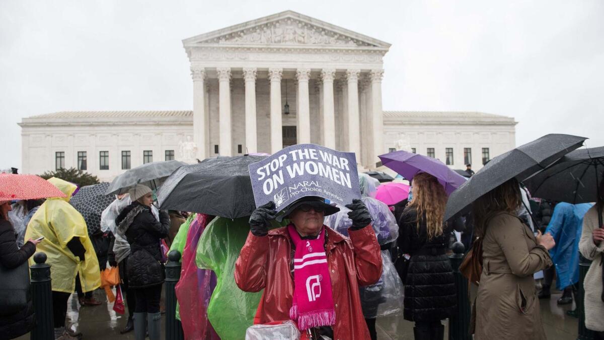 An activist demonstrates in front of the Supreme Court in Washington.