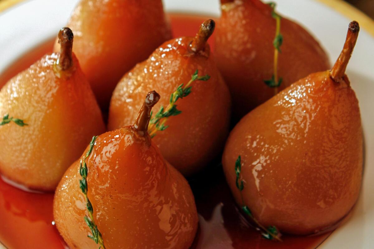 Pears poached in pomegranate wine with honey and sprigs of thyme 