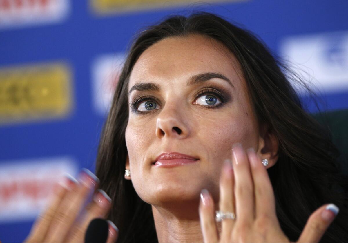 Russian pole vaulter Yelena Isinbayeva has criticized fellow competitors for painting their fingernails in rainbow colors to support gay rights.