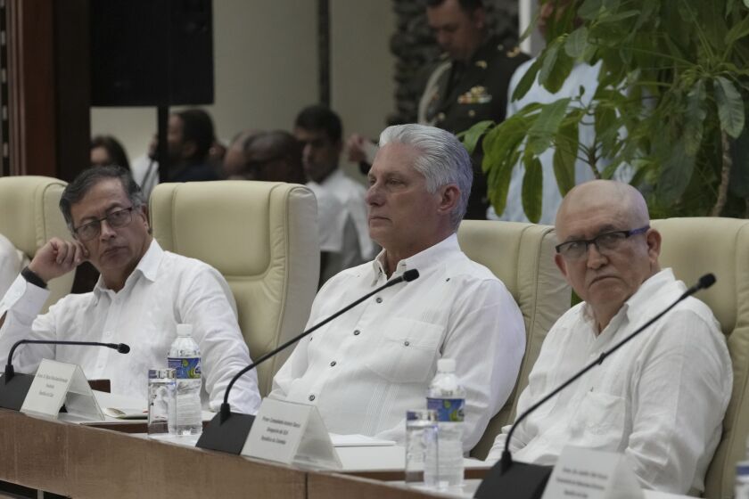 Cuban President Miguel Diaz-Canel sits between Colombia's President Gustavo Petro, left, and ELN commander Antonio Garcia, during a bilateral ceasefire agreement signing ceremony between the Colombian National Liberation Army (ELN) guerrillas and the Colombian government, at El Laguito in Havana, Cuba, Friday, June 9, 2023. (AP Photo/Ramon Espinosa)