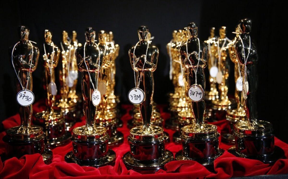 A group of Oscar statuettes.
