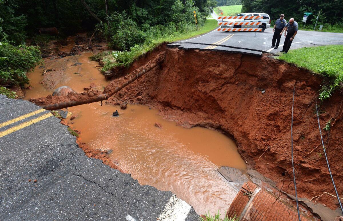 Catawba County deputies survey the damage on Grace Church Rd. near Newton, N.C., after thunderstorms caused heavy flooding.