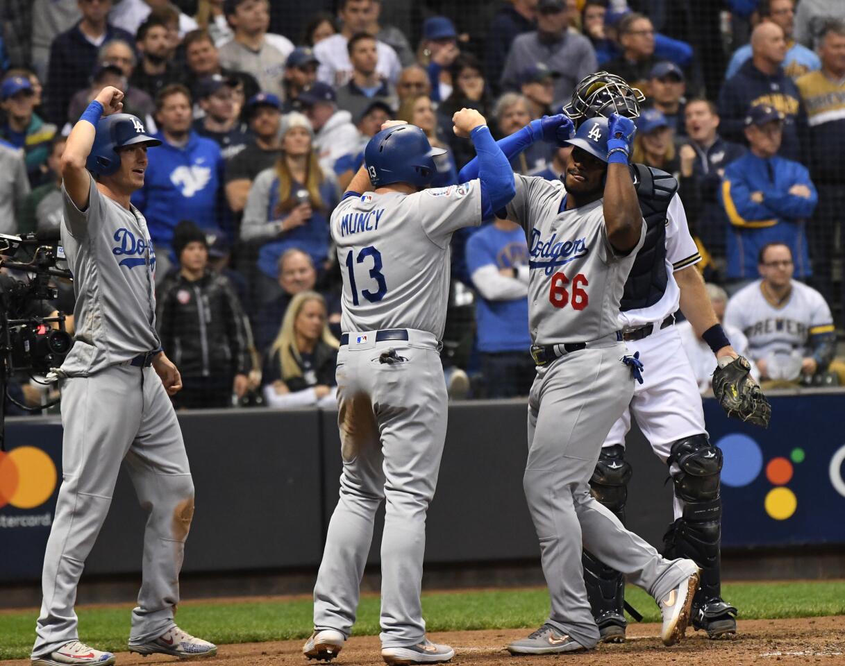 Dodgers Yasiel Puig celebrates with Max Muncy after hitting a three run home run in the 6th inning.