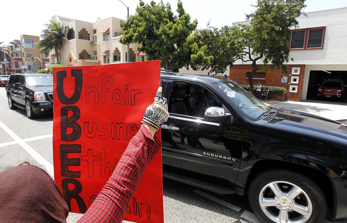 Uber drivers and supporters gather to protest outside of Uber offices in Santa Monica on Tuesday.